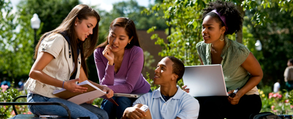 Group Of Ethnically Diverse Students Studying Together Outside